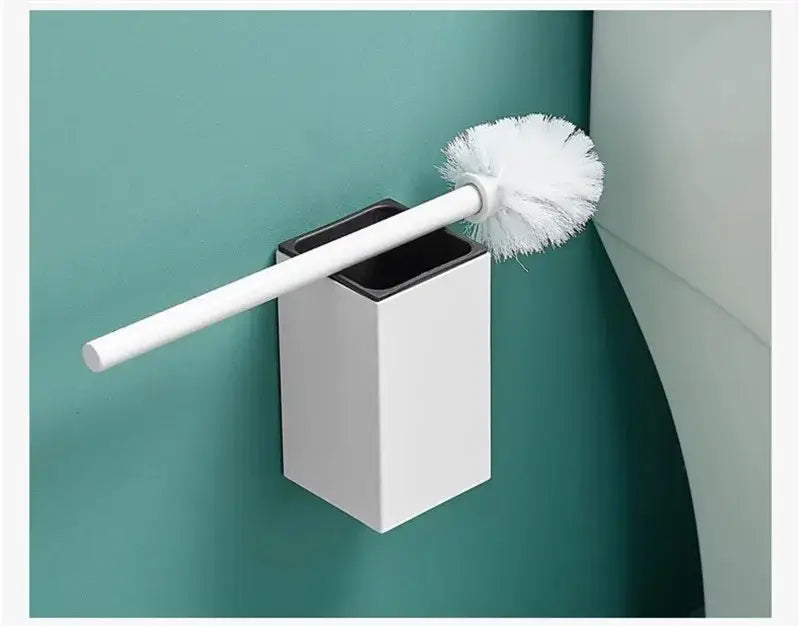 White toilet brush with soft fluffy bristles in a sleek white aluminum decorbites toilet brush holder mounted on wall