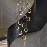 Modern minimalist aluminum led chandelier with polished metallic rings and warm ambient glow for luxury staircase lighting