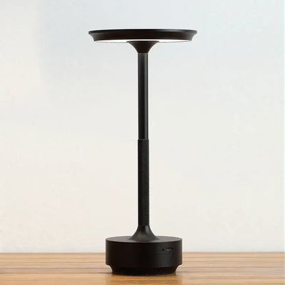 Black minimalist aluminum led desk lamp with sleek cylindrical stem and circular light head for living room use