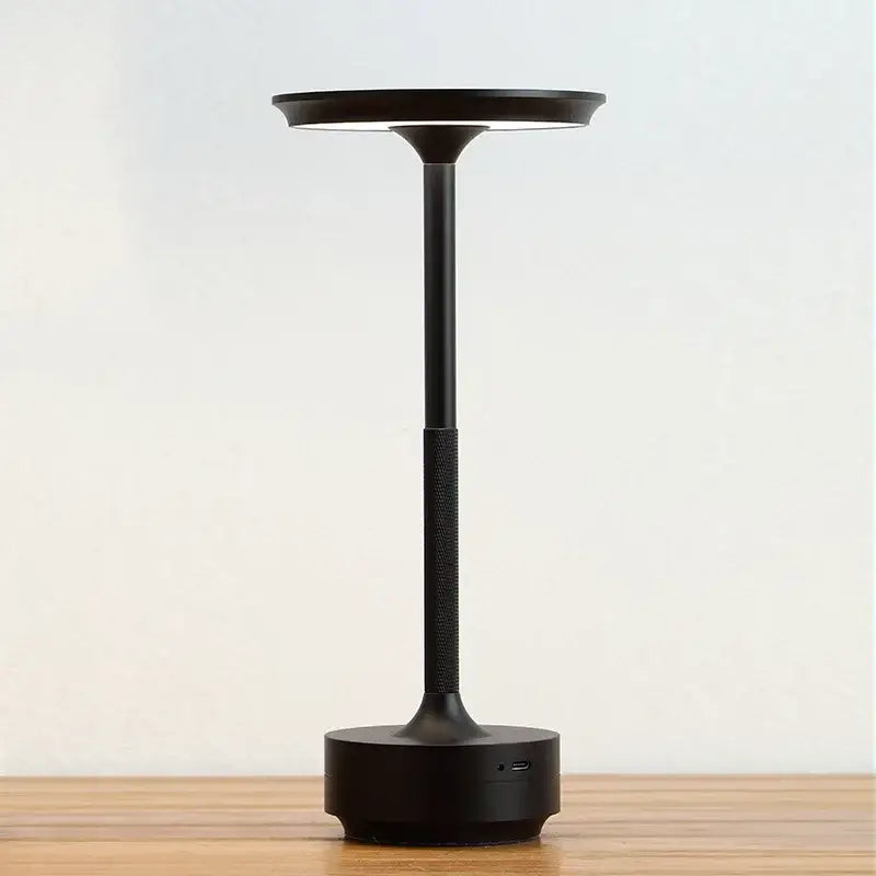 Black minimalist aluminum led desk lamp with sleek cylindrical stem and circular light head for living room use
