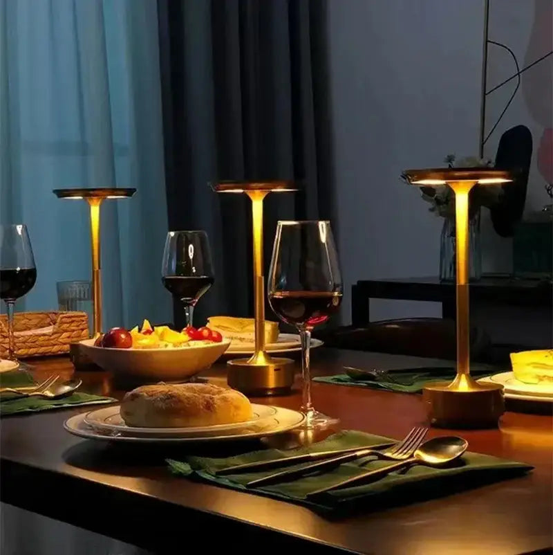 Gold-colored aluminum led desk lamp with sleek cylindrical base and flat top emitting warm glow for living room use