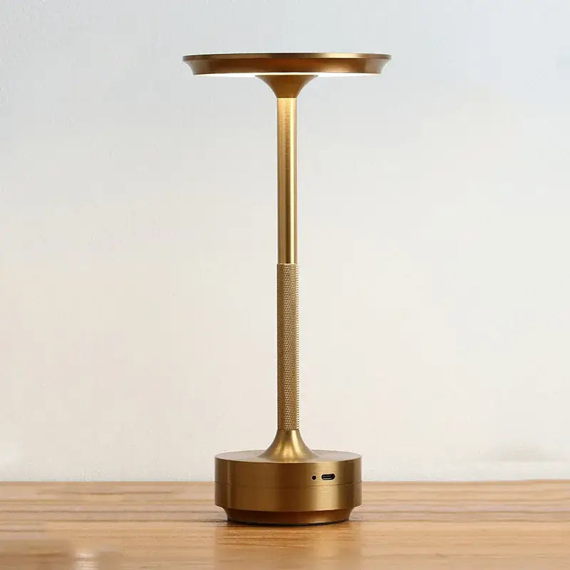 Gold-finished aluminum led desk lamp with sleek modern design textured grip circular base and usb port for living room use