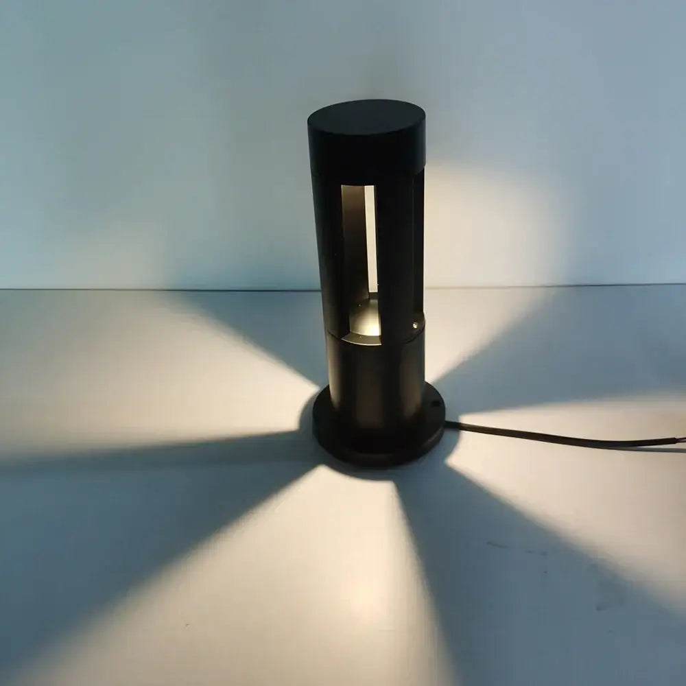 Black aluminum led garden light with cylindrical design and starburst cutouts for outdoor landscape lamp use