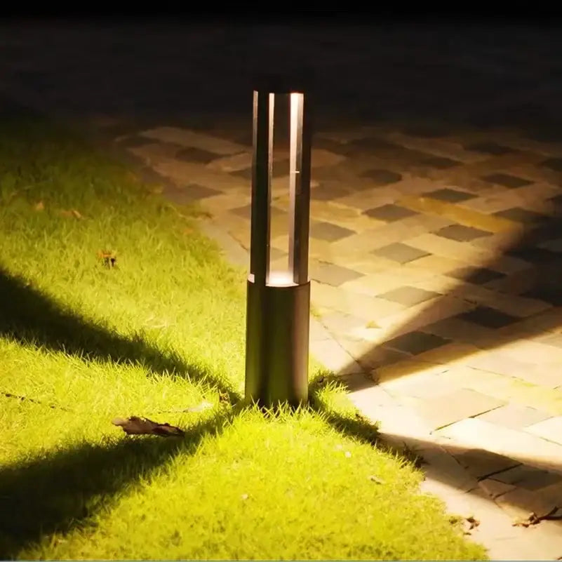 Modern black aluminum led garden light with cylindrical design and vertical slits for warm outdoor landscape lamp lighting