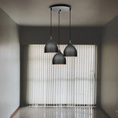 Modern black aluminum led pendant light with sleek teardrop shades hanging from circular ceiling fixture for living room