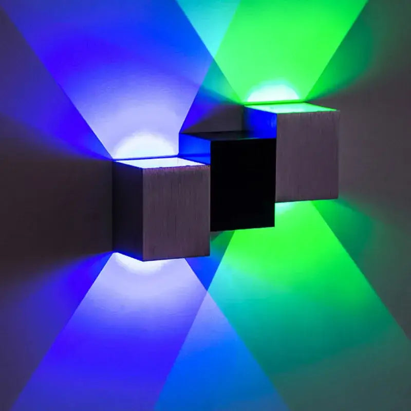 DecorBites aluminum led wall lamp with three interlocking cubes emitting vibrant blue and green light for living spaces