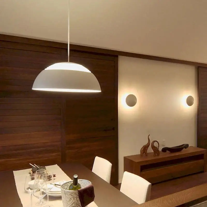 White dome-shaped decorbites aluminum pendant lamp with modern design hanging over dining room or kitchen island