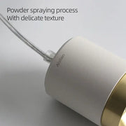 A sleek white decorbites aluminum pendant light with gold accent band and matte finish for living room use