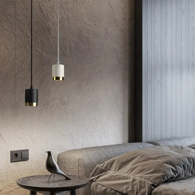 Two minimalist pendant lights in black and white aluminum with gold trim from decorbites aluminum pendant light series