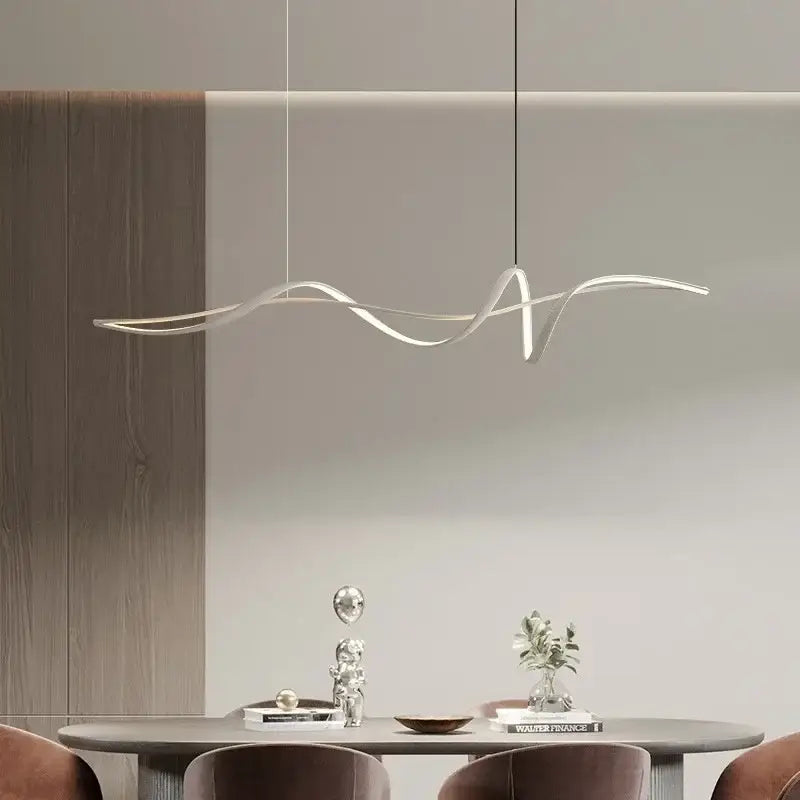Modern silver-toned decorbites aluminum pendant light with sleek wave design suspended above dining table chandelier
