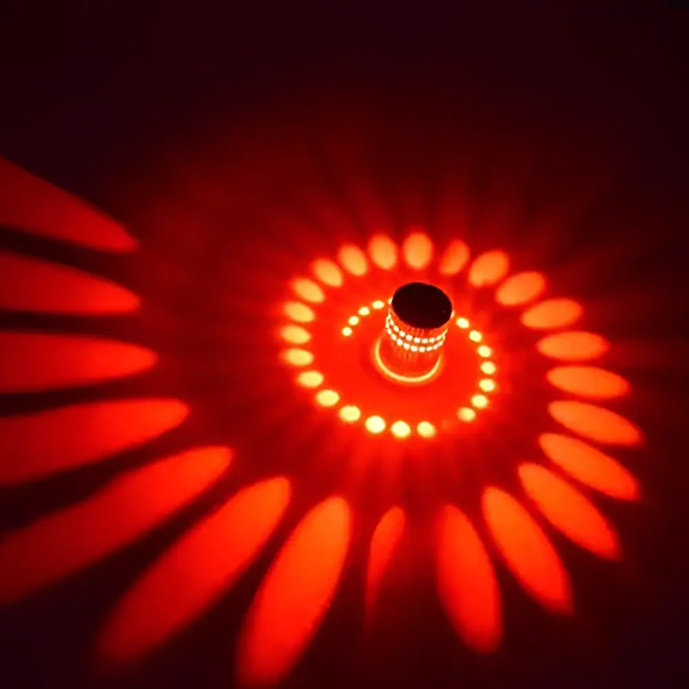 Decorbites aluminum spiral led wall lamp in red casting a warm orange and crimson spiral pattern for bedroom and living room