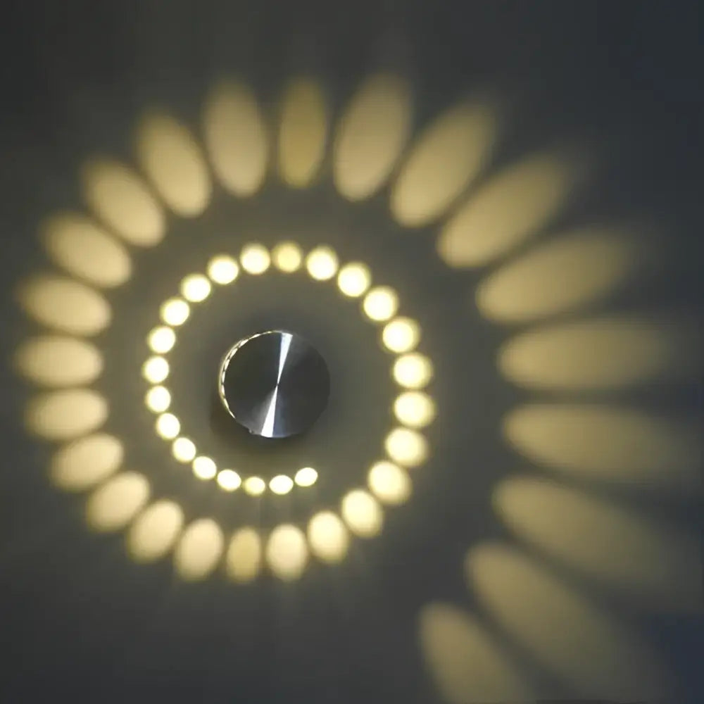 Decorbites aluminum spiral led wall lamp with sleek metallic center and warm yellow concentric led rings for living room