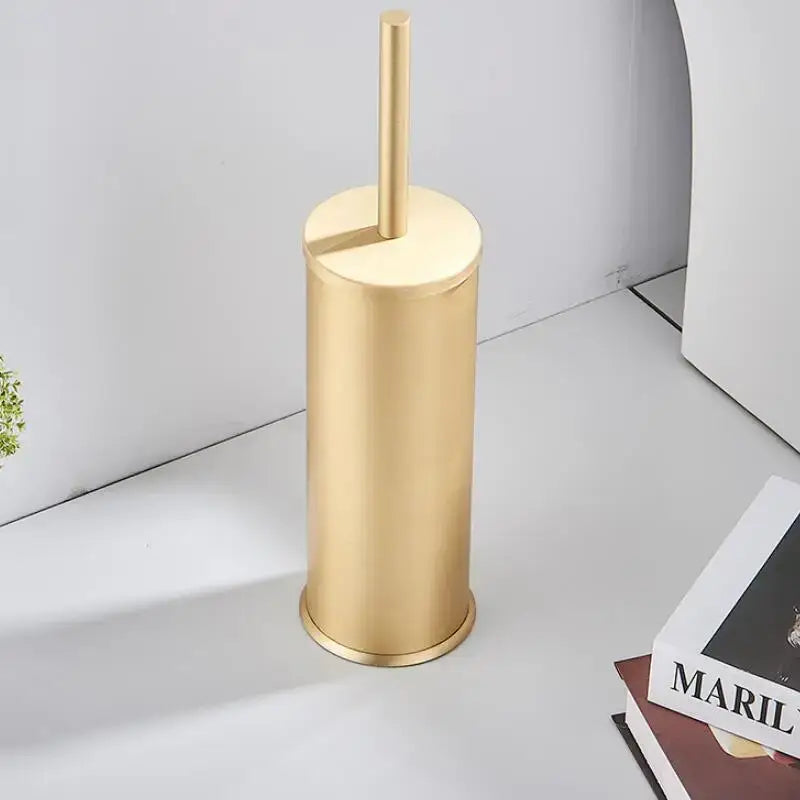 Decorbites aluminum toilet brush holder set in brushed gold features a sleek metallic cylindrical brush holder and handle