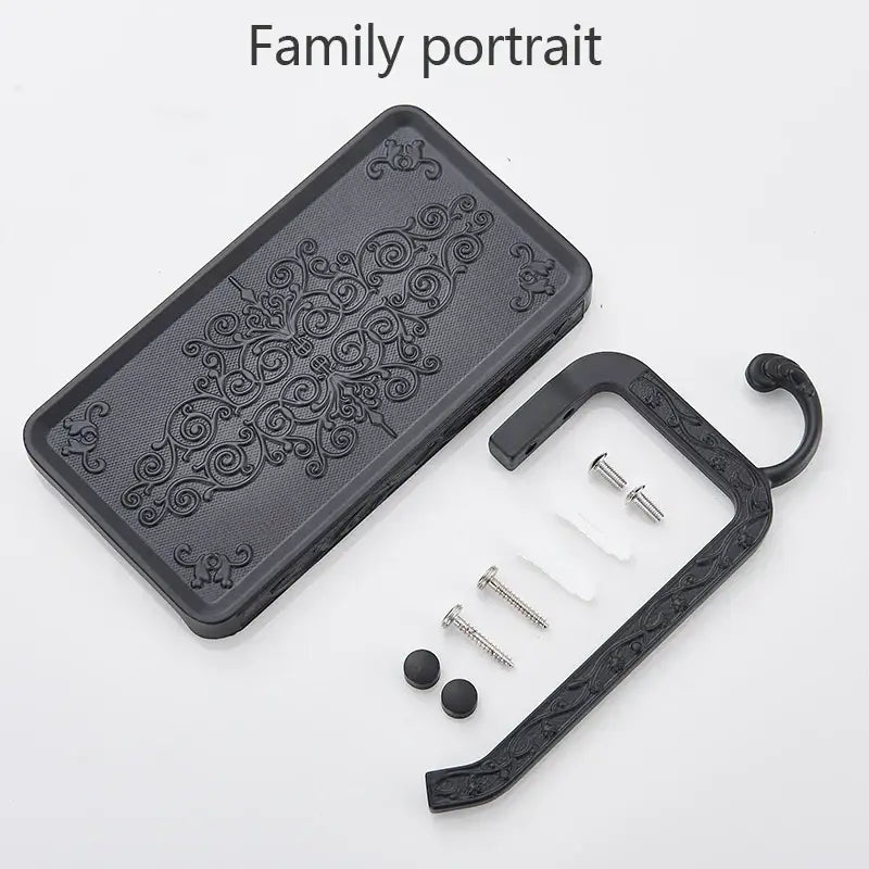 Black ornate aluminum toilet paper holder with phone rack and hook featuring intricate scrollwork design decorbites paper holder