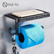 Black ornate aluminum toilet paper holder by DecorBites with a sleek phone rack shelf and hook holding keys