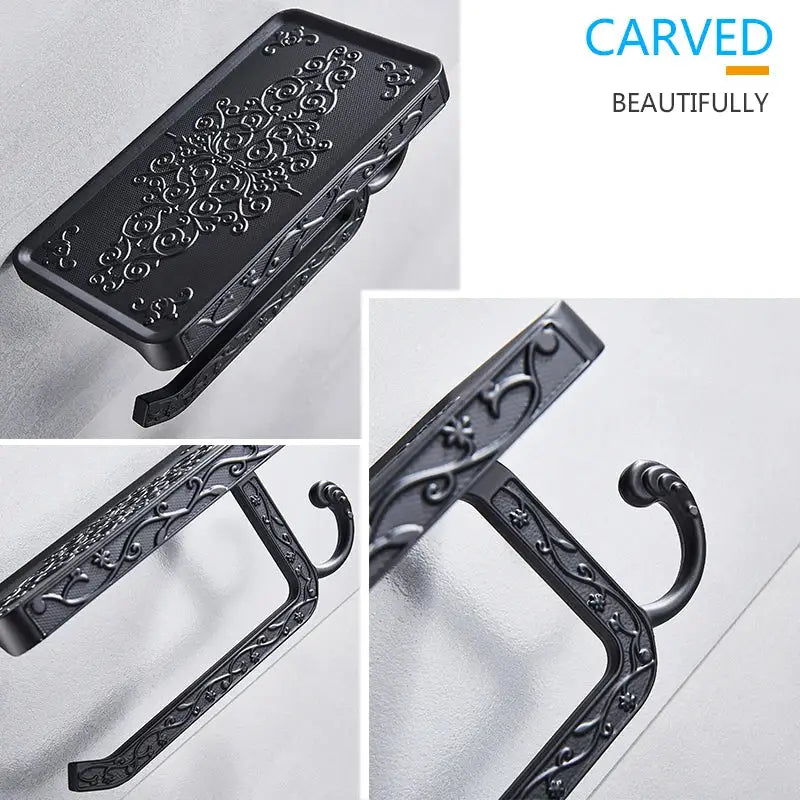 Black carved aluminum DecorBites™ toilet paper holder with ornate scrollwork design, phone rack, and hook