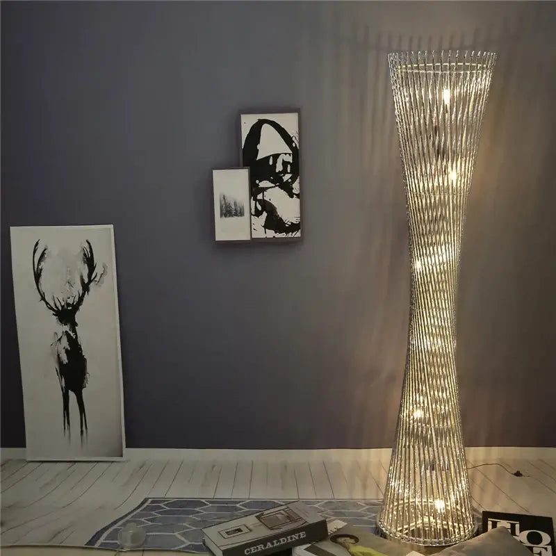 A tall slender decorbites aluminum tower floor lamp with twisted crystal design and warm LED lighting for living room decor