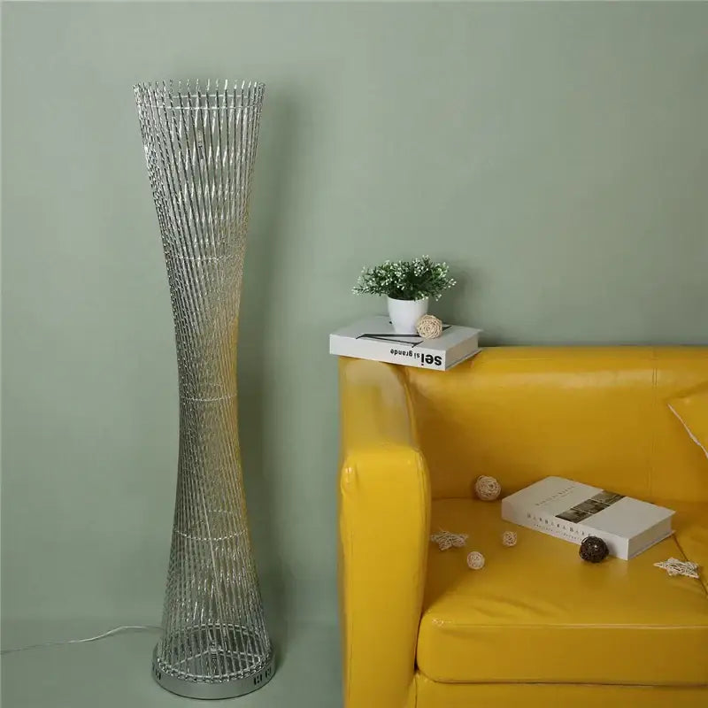Silver metallic DecorBites aluminum tower floor lamp with tall slender twisted wireframe design for modern living room decor