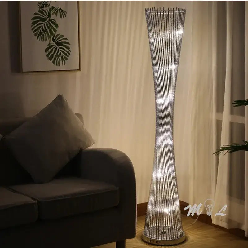 Modern silver aluminum tower floor lamp with twisted wireframe design and embedded led lights for living room use