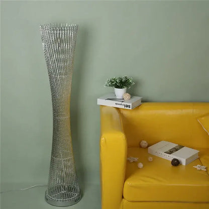Silver metallic DecorBites™ aluminum tower floor lamp with slender twisted wireframe design for modern living room decor