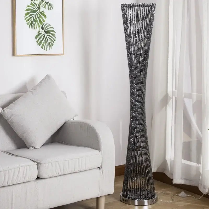 Tall slender decorbites aluminum tower floor lamp with dark metallic finish and intricate woven aluminum tower floor design