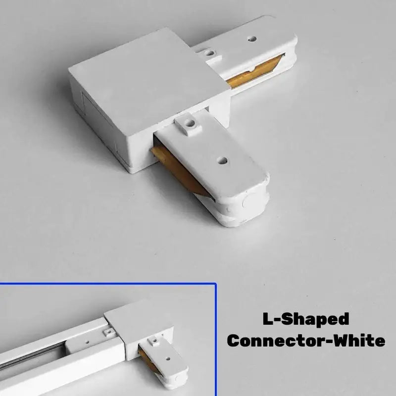 White l-shaped aluminum track rail connector with matte finish and gold-colored contacts for DecorBites track lighting system