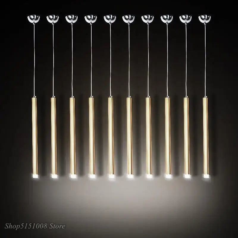 Ten modern gold-toned aluminum tube pendant lights with chrome tops and warm glow by decorbites pendant light for dining room