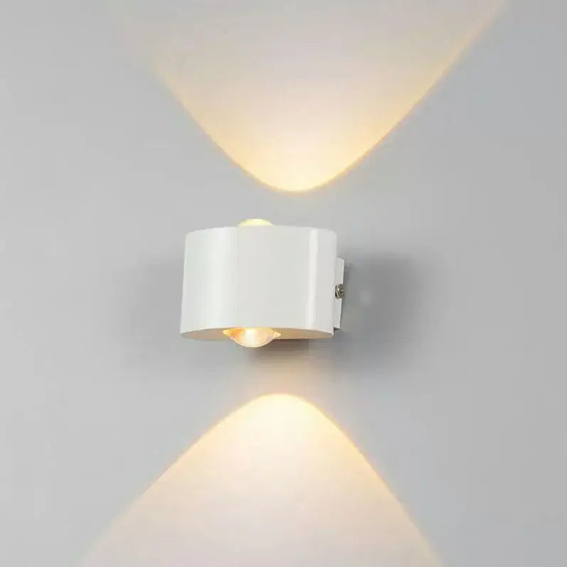 White cylindrical DecorBites aluminum wall lamp with dual downward light beams for bedside and living room lighting