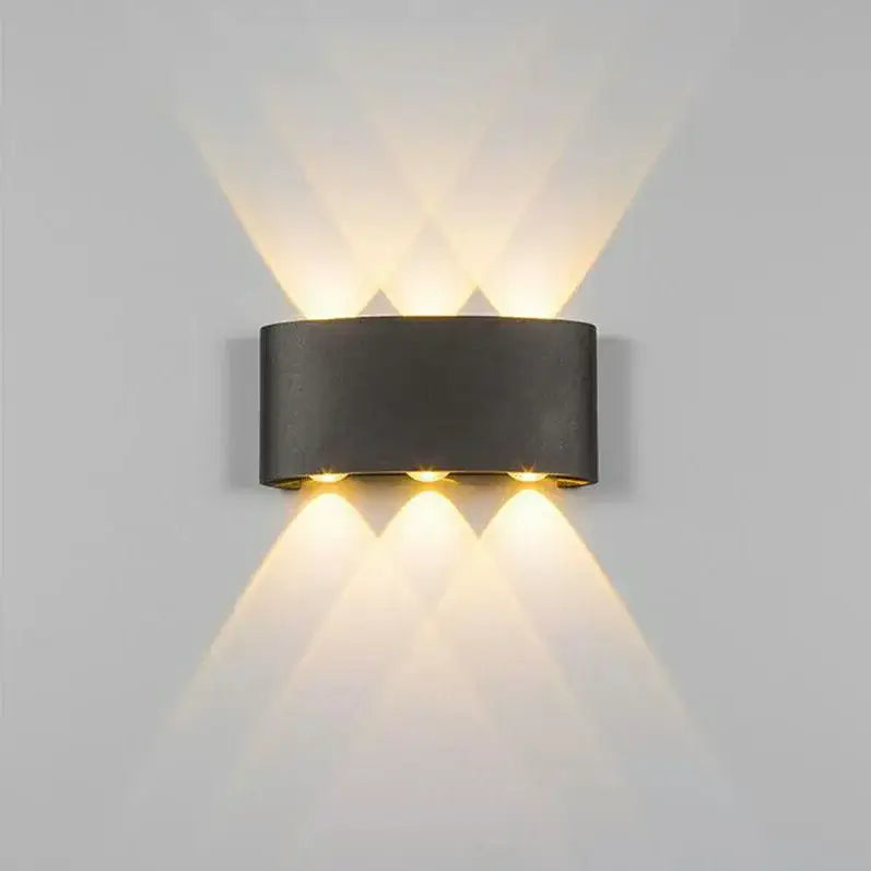 Modern black cylindrical decorbites aluminum wall lamp with three warm lights casting geometric patterns for living rooms