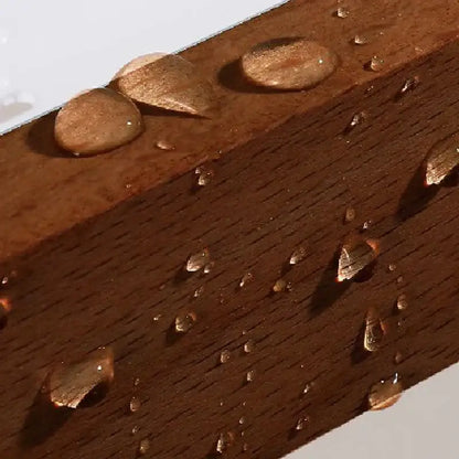 Decorbites aluminum and walnut towel ring with rich brown walnut beam featuring visible grain and water droplets