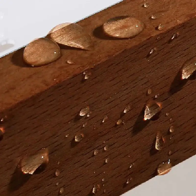 Decorbites aluminum and walnut towel ring with rich brown walnut beam featuring visible grain and water droplets