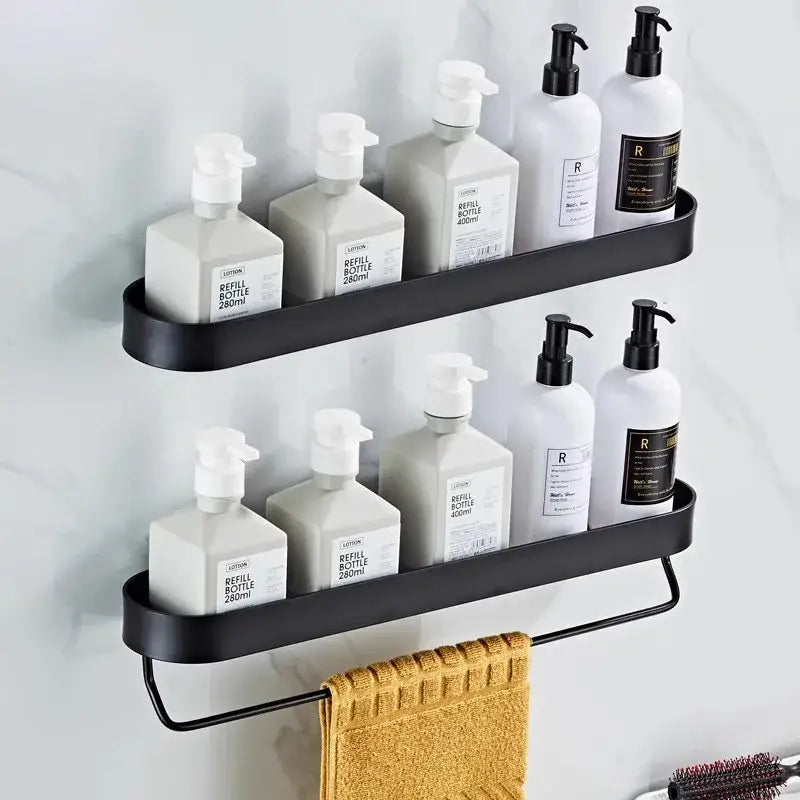 Black metal decorbites bathroom shelf with two tiers towel bar and corner storage shelf holding white pump bottles