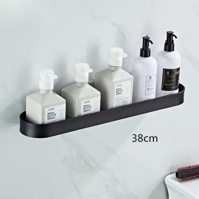Black metal DecorBites™ aluminum bathroom shelf with towel bar and corner storage shelf holding five white pump bottles