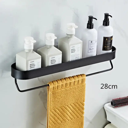 Black metal bathroom shelf with towel bar and corner storage shelf holding white pump bottles and mustard-yellow towel