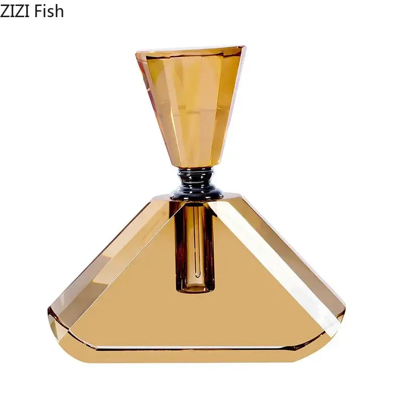 A faceted amber crystal perfume bottle with a geometric pyramid base and tapered neck for aromatherapy use