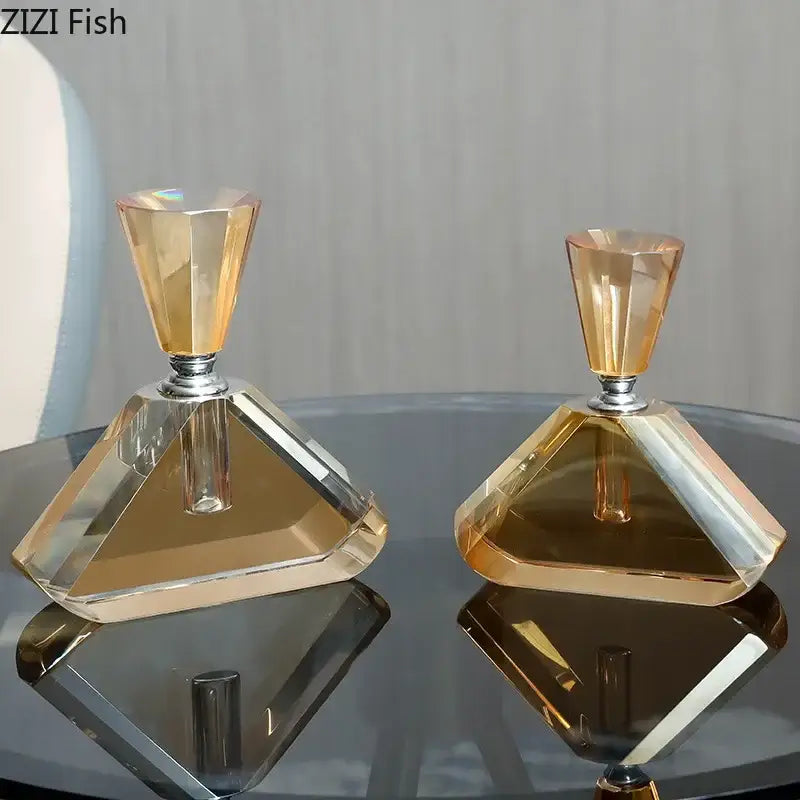 Two elegant faceted crystal perfume bottles with amber crystal glass and silver caps for aromatherapy use