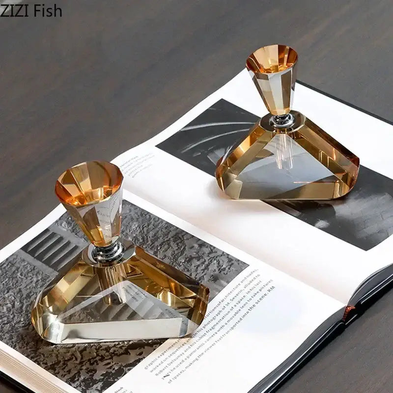Two elegant faceted amber crystal perfume bottles with metallic silver caps for decorative aromatherapy use