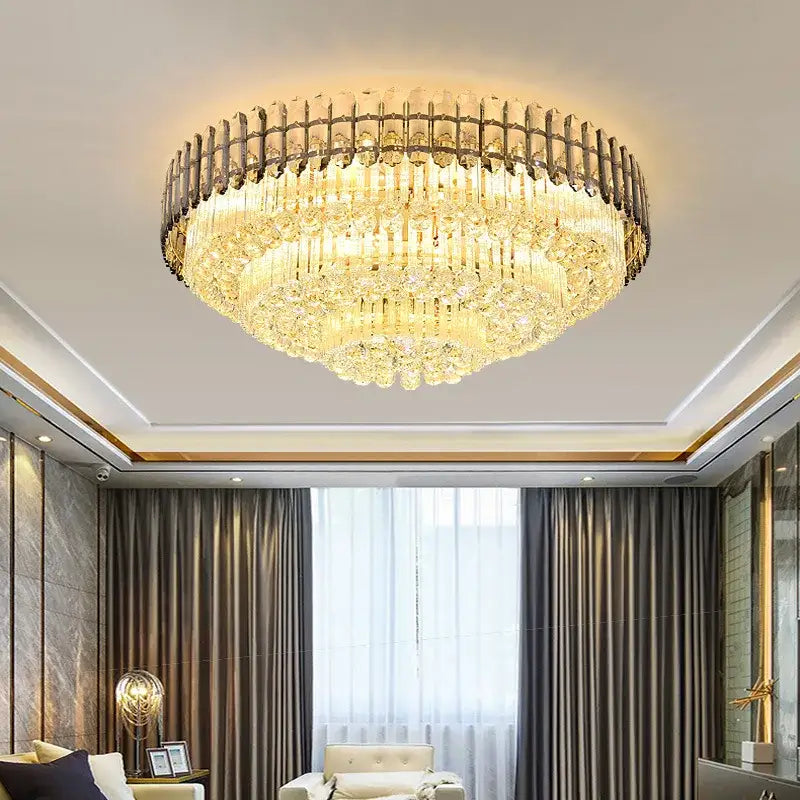 A luxurious gold-toned decorbites amber crystal round chandelier with cascading tiers of faceted glass for living room