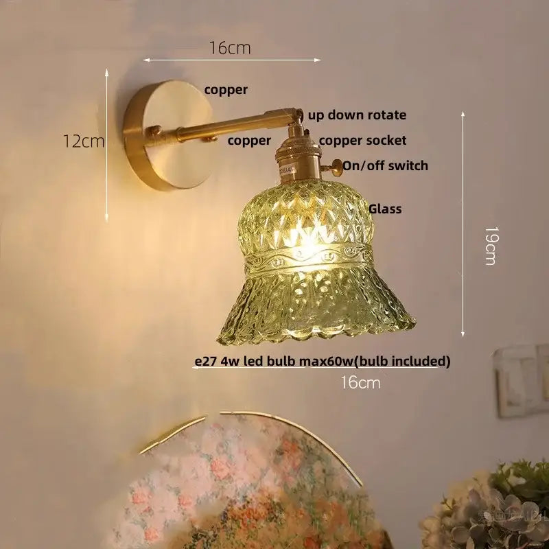 Antique brass-finished wall light with amber flower glass LED shade featuring diamond-cut patterns for kitchen or bar
