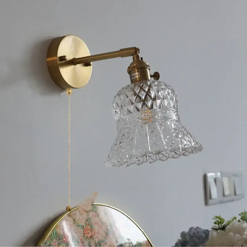 Antique brass DecorBites™ wall light with amber flower glass LED shade featuring diamond-cut scalloped design