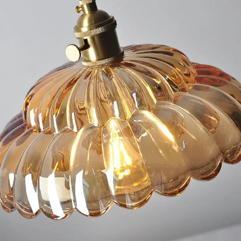 Amber flower glass pendant light with scalloped design and brass finished socket for kitchen or reading room decor