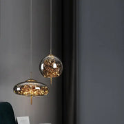 Decorbites amber glass chandelier featuring two modern glass pendant lights with golden fixtures and internal string lights