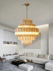 Golden tiered amber glass chandelier with cascading crystal rods suspended by brass chain for living and dining room