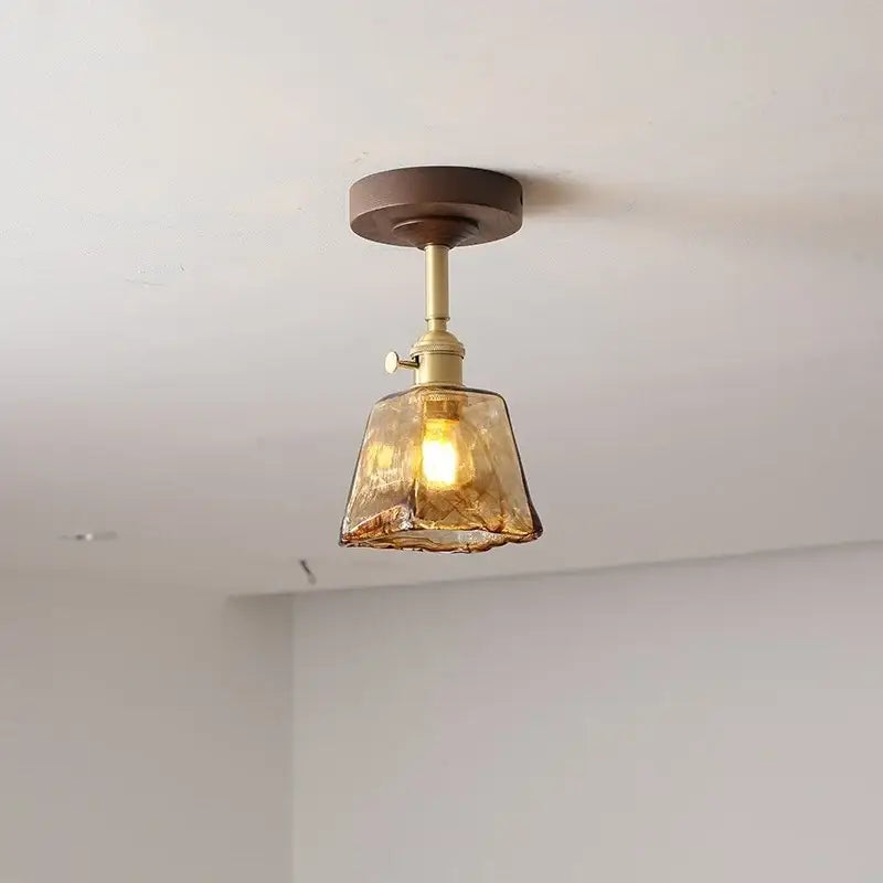 DecorBites amber glass copper ceiling light fixture with warm amber glass, brass stem, and dark wood mount for modern decor