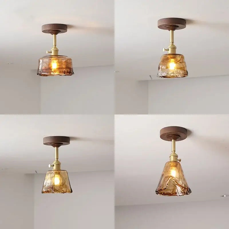 Warm amber glass ceiling light fixture with brass finish and dark wood mount for modern home decor by decorbites