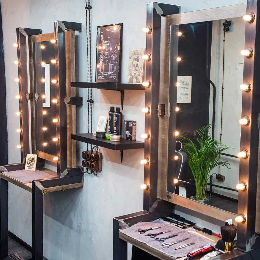 Industrial-style vanity mirror with dark metal frame and warm amber glass led filament bulb lights around edges