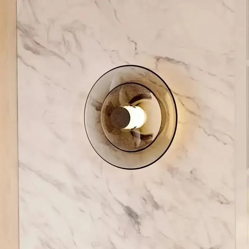 Decorbites amber glass disc wall lamp with a modern circular frosted glass disc shade and warm LED bulb lighting