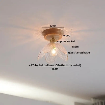 A delicate flower-shaped amber glass led ceiling light with textured finish on copper socket and wooden base for modern decor