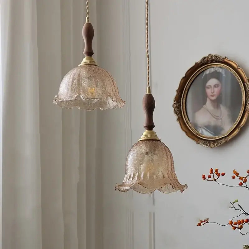 Two vintage-style pendant lamps with amber glass led textured shades and walnut wood copper hanging stems