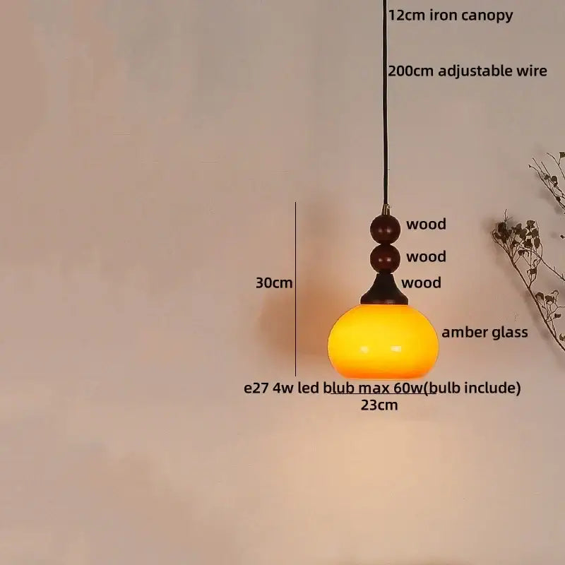 DecorBites amber glass led pendant light with warm amber glass shade wooden base and dark wood beads for rustic interiors